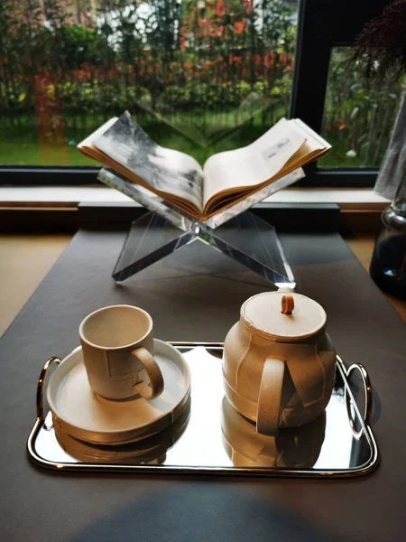 cup of coffee and a book on the table