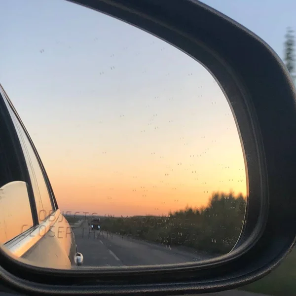 car wheel, driving through the window, sunset, clouds, sky, sun, sunlight