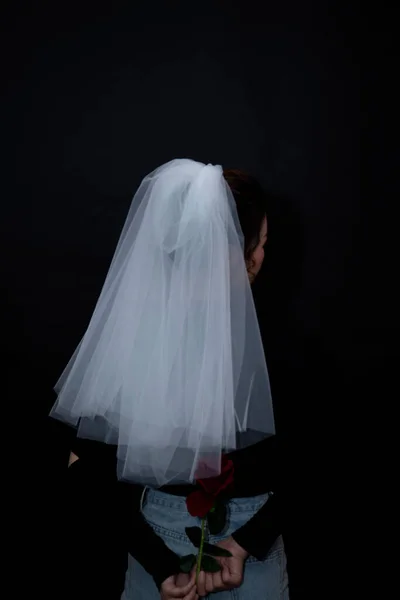beautiful young woman with a veil on a black background