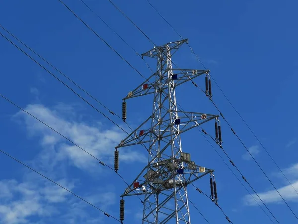 high voltage power line against blue sky