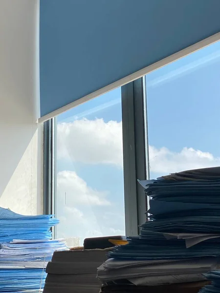 stack of papers and documents on the background of the window