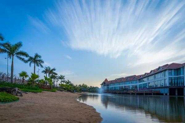 beautiful tropical resort hotel and sea with palm trees and blue sky