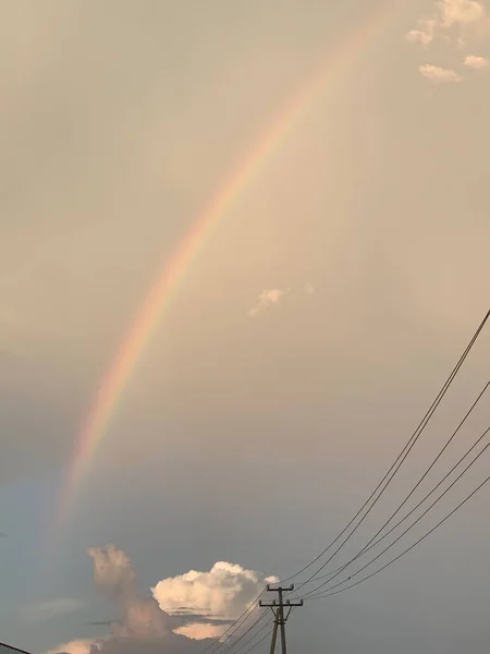 rainbow sky with clouds and sun