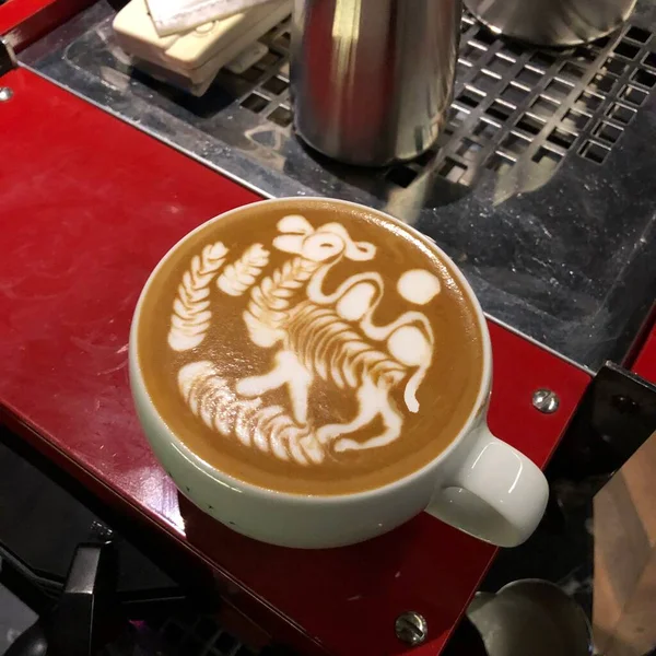 coffee cup with latte art on the table