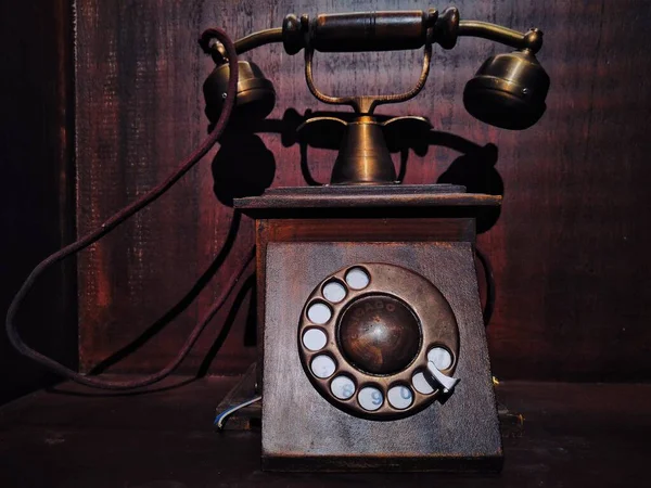 old vintage telephone on wooden table