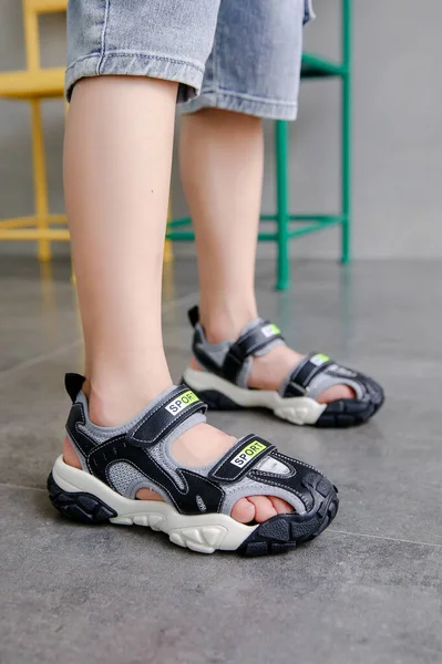 woman legs in sneakers and shoes on the street