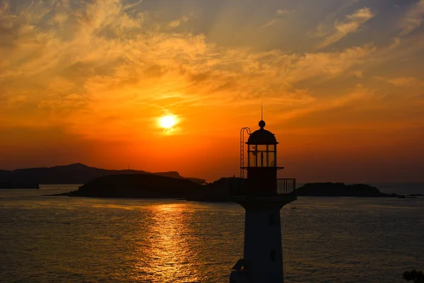 lighthouse at sunset, italy