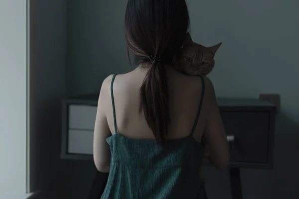 beautiful young woman with cat in the room