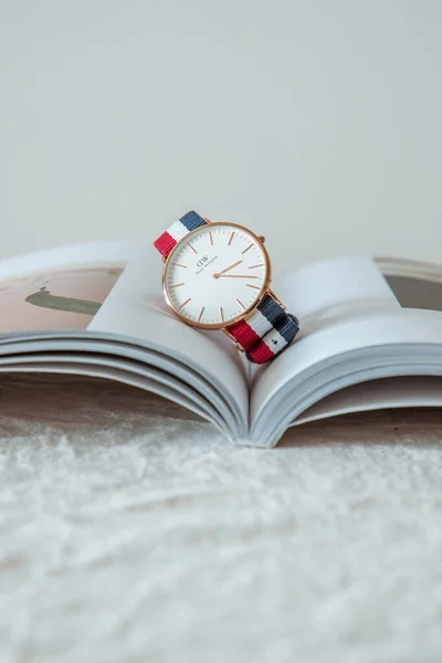 open book with a stack of books on a white background