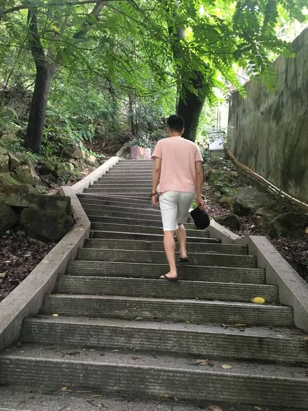 man walking on the stairs of the bridge