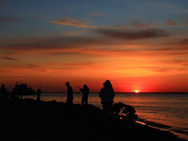 silhouette of a man and woman on the beach