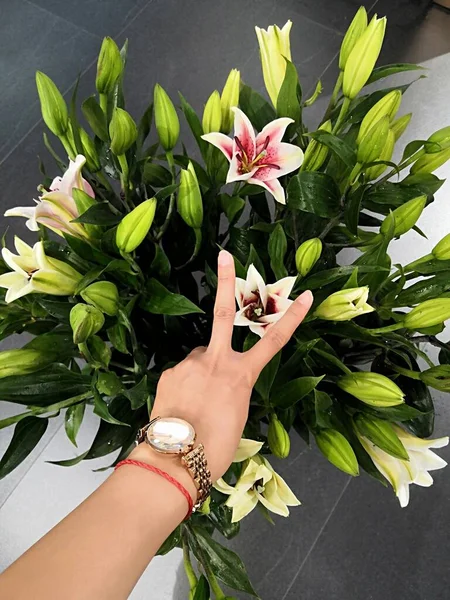 female hands with a bouquet of flowers
