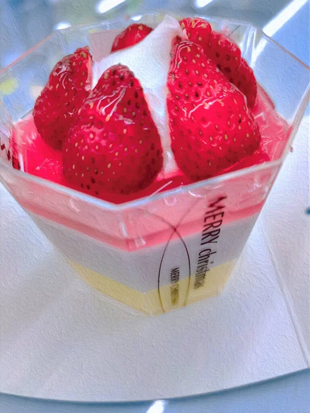 red and white strawberries in a plastic box