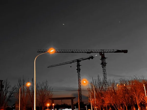 construction cranes and building on background of the city