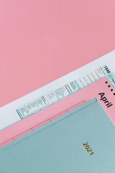 close-up of a red and pink medical note with a pen on a white background