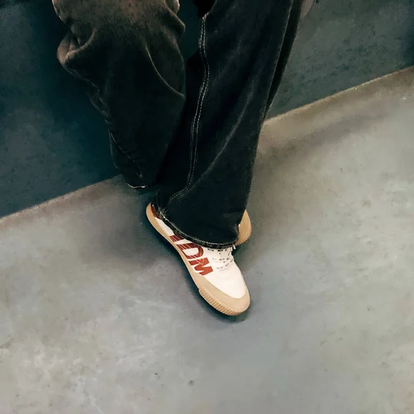 man legs in black shoes on a gray background