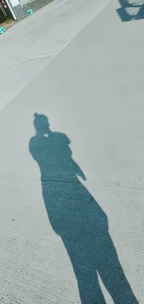 silhouette of a man walking on the street