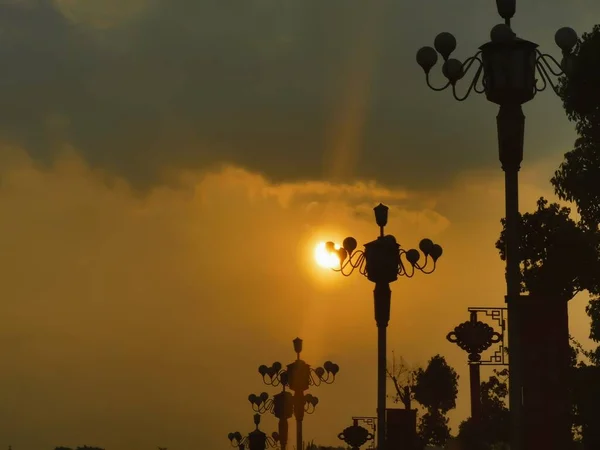 silhouette of a street lamp on the background of the sunset