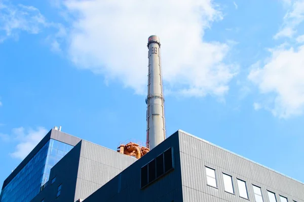 industrial factory, chimney, blue sky and clouds