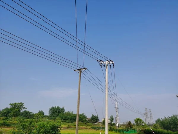 high voltage power line on a background of blue sky