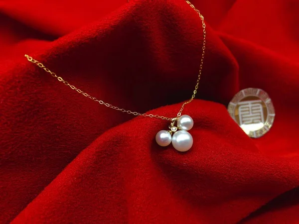 red and white pearls with a pearl necklace on a black background