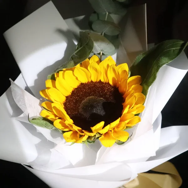 beautiful bouquet of yellow sunflowers in a vase on a black background
