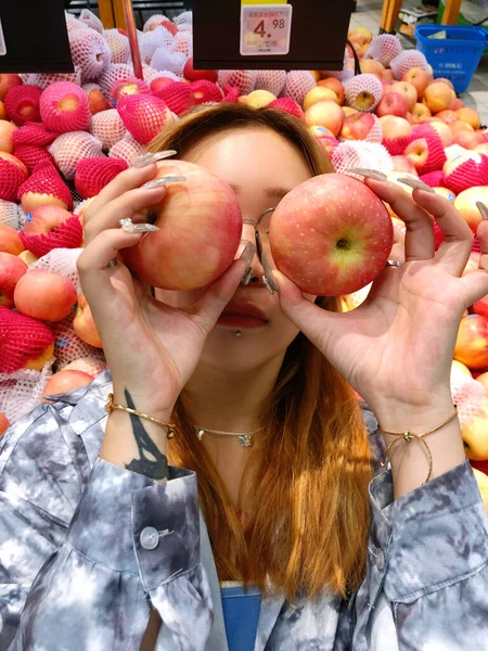 woman with red apples in the store