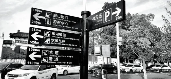 black and white photo of a street signs in the city of barcelona