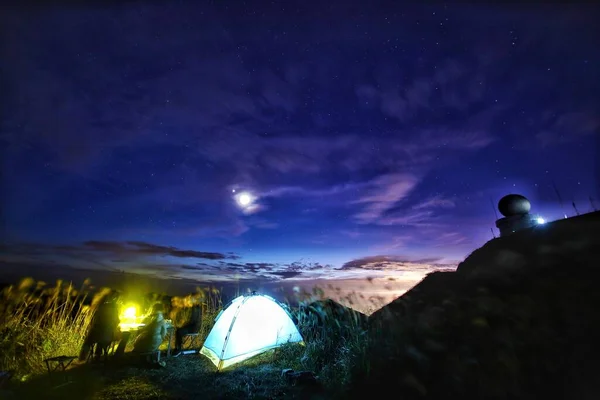 camping tent with stars and moon in the night sky