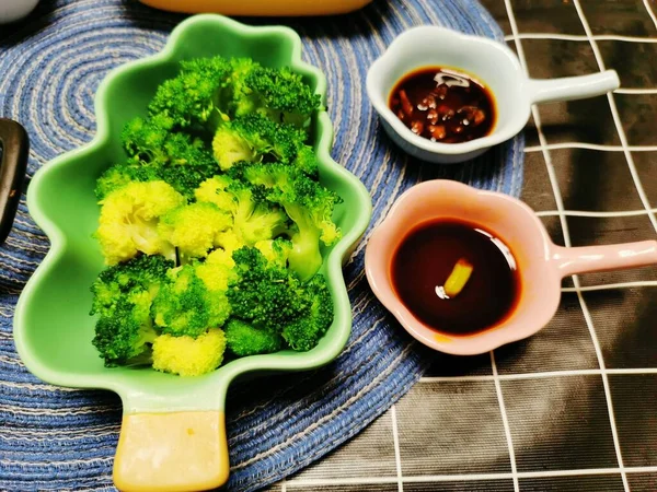 green cabbage and broccoli in a bowl on a wooden table