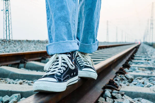 woman legs on the railway tracks