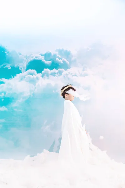 beautiful bride in white dress and veil on the beach