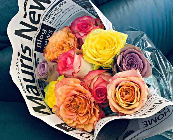 roses and money on a wooden background