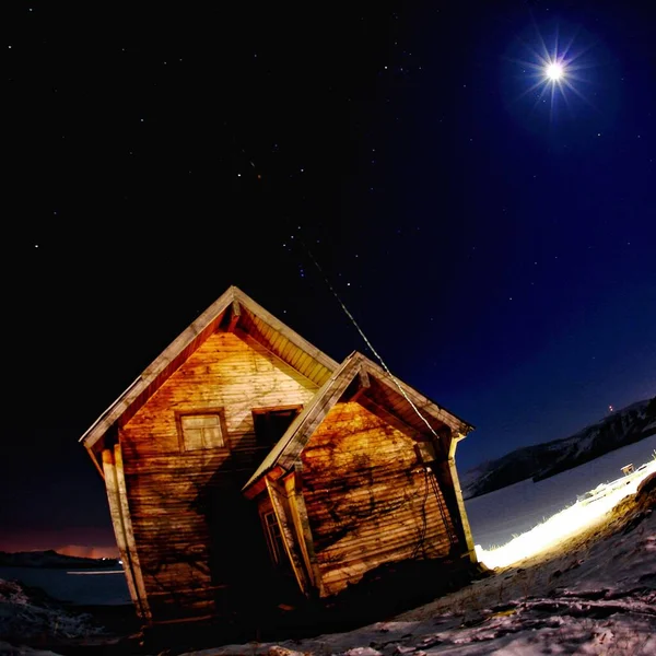 wooden house in the night sky