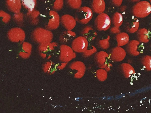 red currant berries on a black background