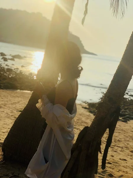 beautiful young woman with a veil on the beach