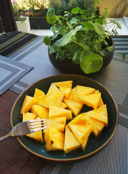 fresh pineapple and mango slices on a plate