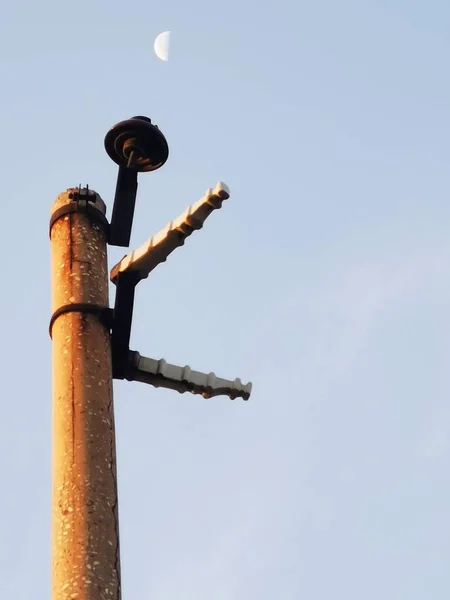 old rusty metal pole on the roof of the house