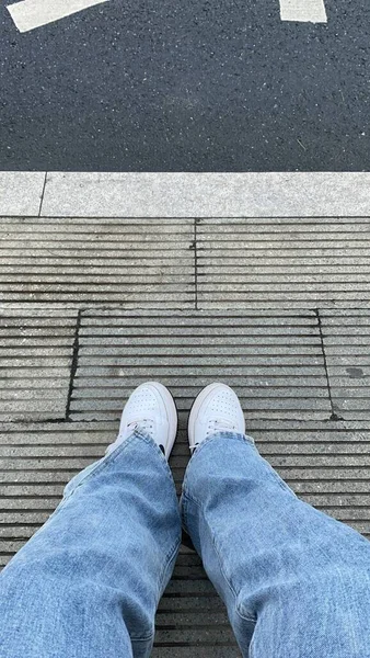 feet of a man\'s legs on the floor