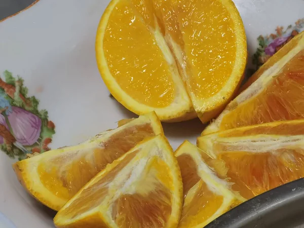 fresh sliced orange slices on a white plate