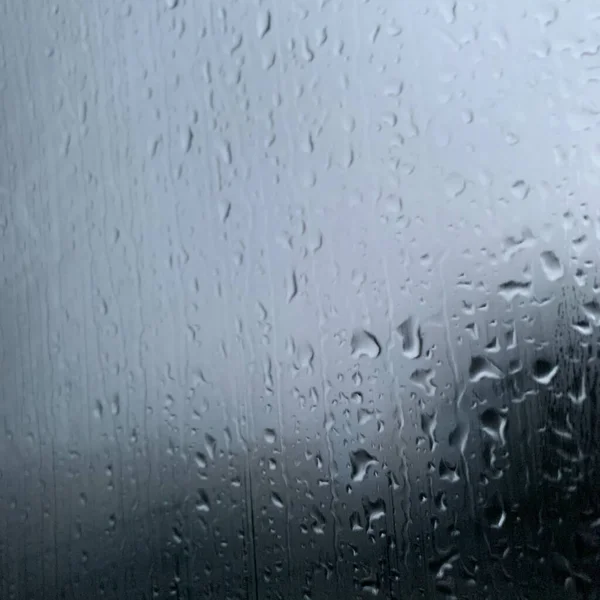 rain drops on glass, wet window, rainy weather, raindrops on the water, close-up