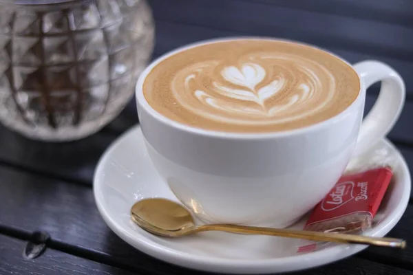 cup of cappuccino coffee with a white background