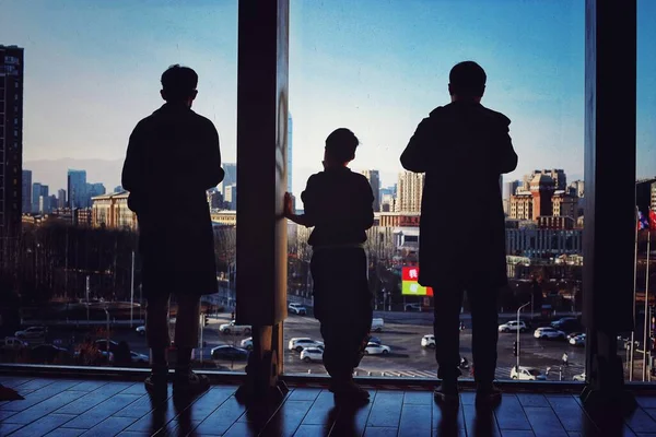 silhouettes of business people walking in the city