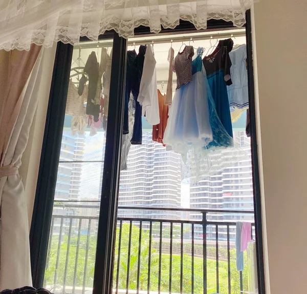 wedding dress hanging on the window