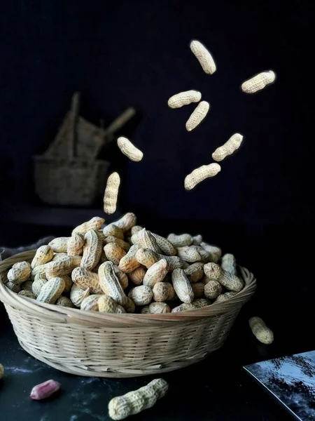 close up of a pile of nuts on a black background