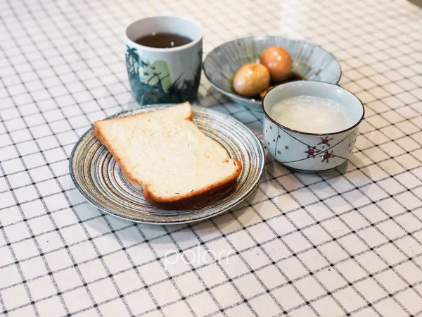 breakfast with coffee and bread, cup of tea and egg