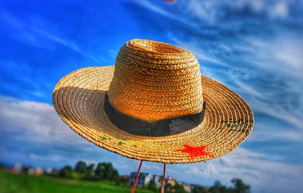 straw hat on the background of the blue sky