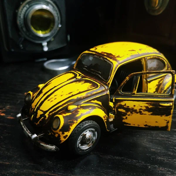 yellow car toy on a black background