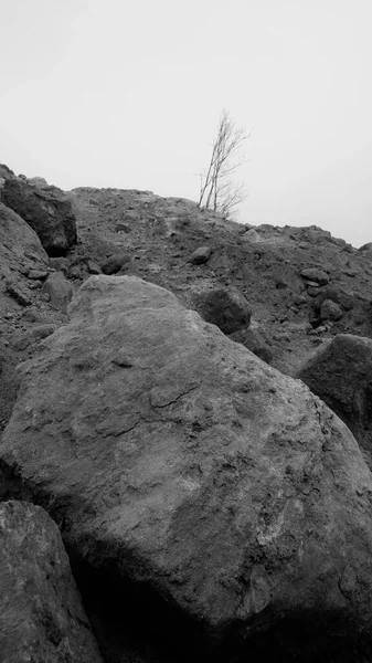 black and white photo of a rock formations in the mountains