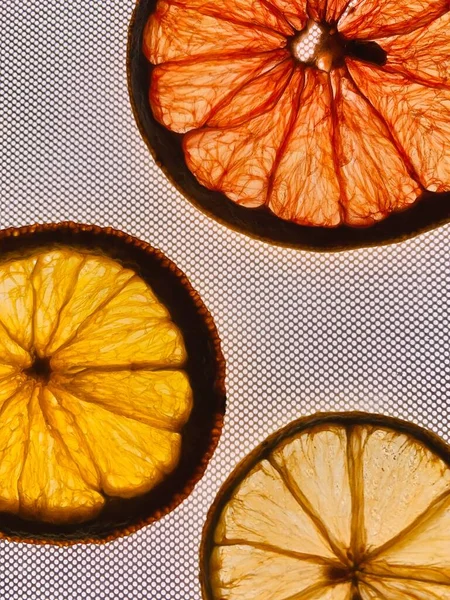 dried oranges and orange slices on a wooden background.